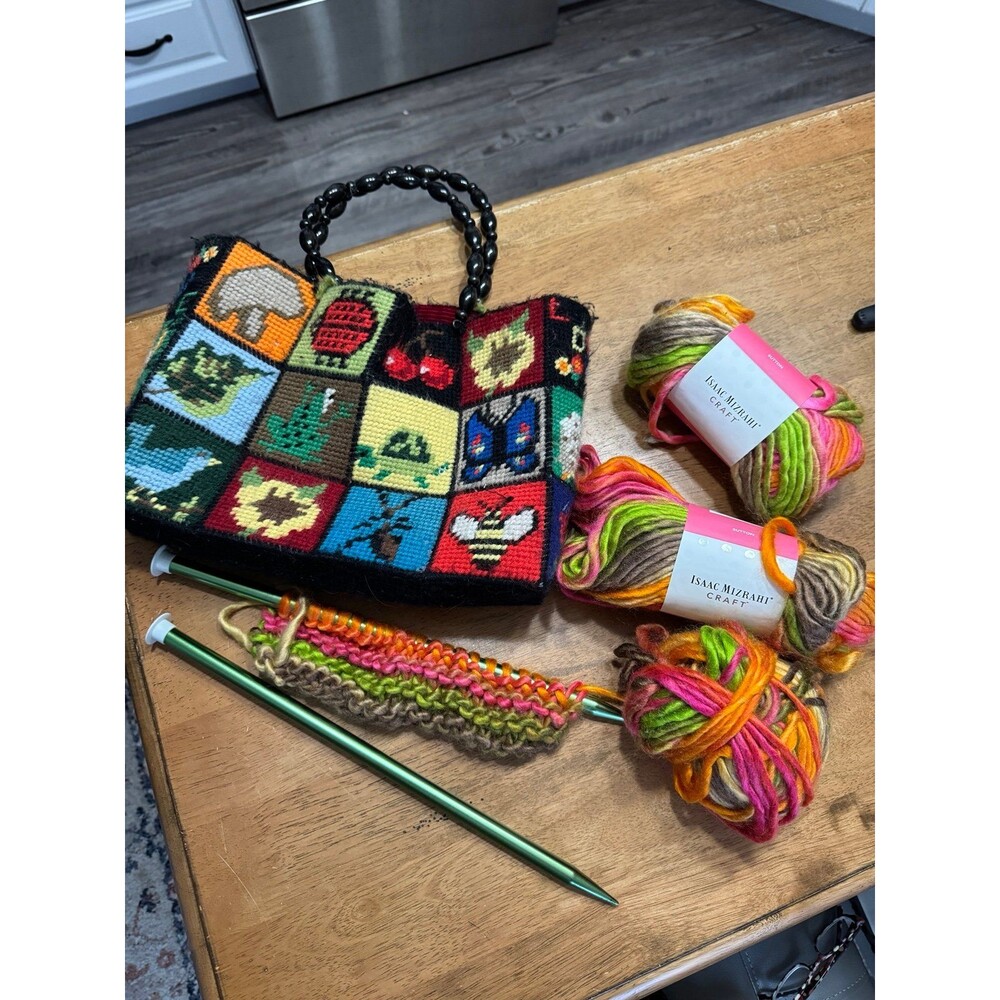 vintage 1970s handmade needlepoint handbag featuring a patchwork design of bugs